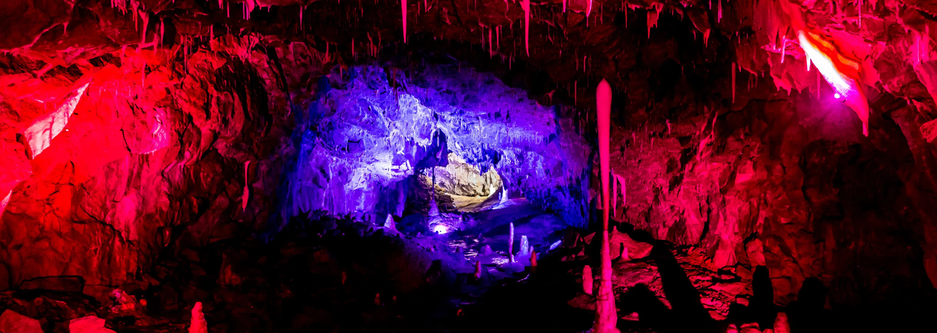 Red and purple cave with a glowing blue center.