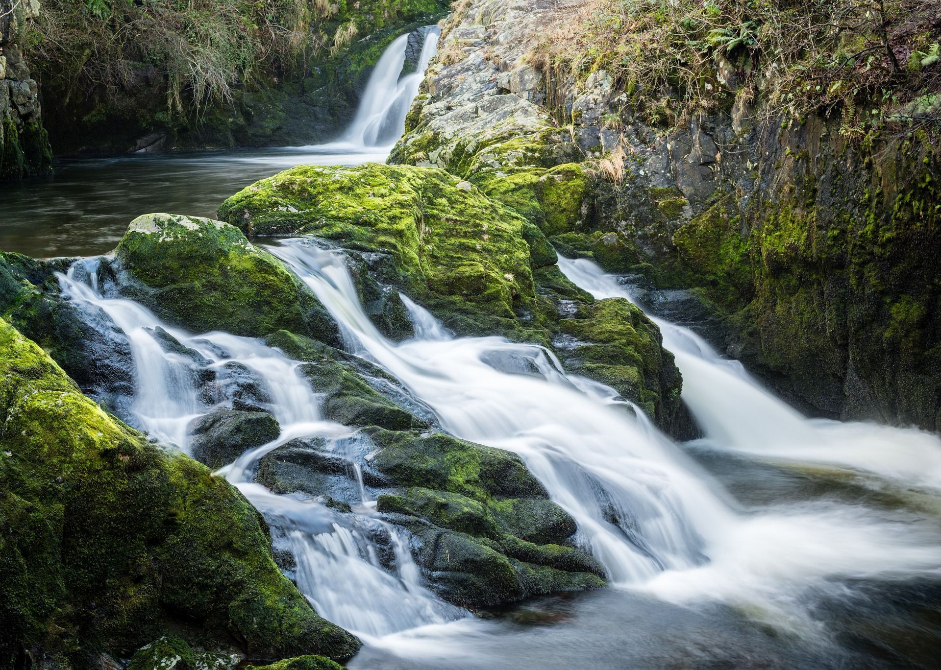 Waterfall cascading over mossy rocks.