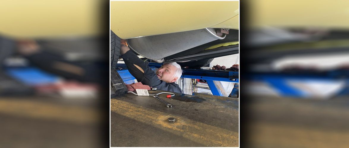 A mechanic working on a vehicle | Alpine Automotive Service