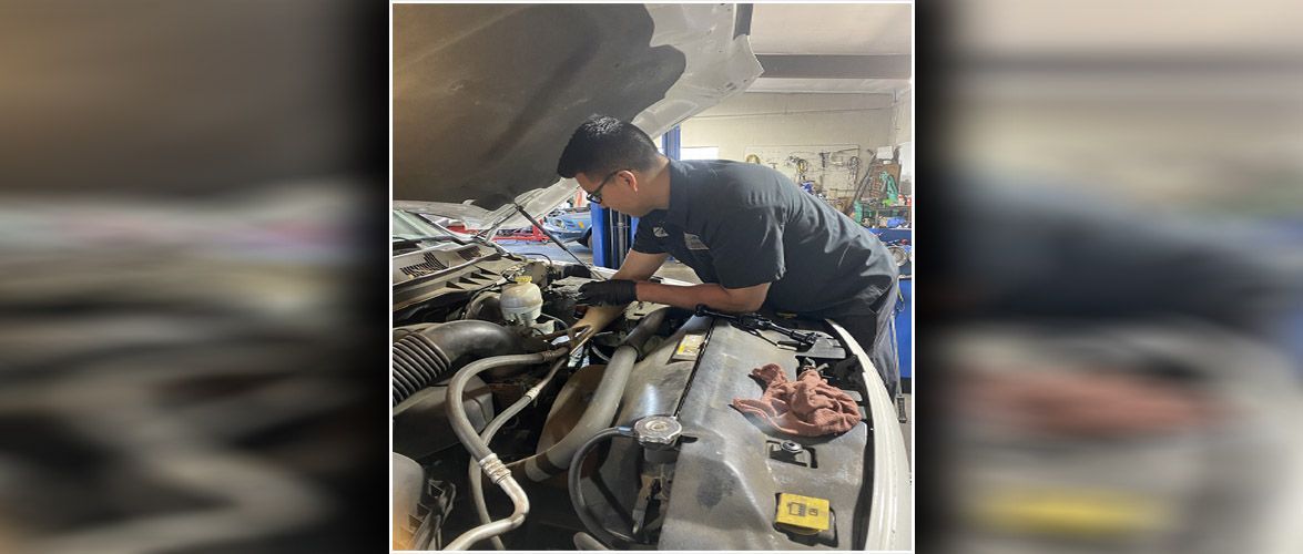 A technician working on a vehicle at our repair shop | Alpine Automotive Service