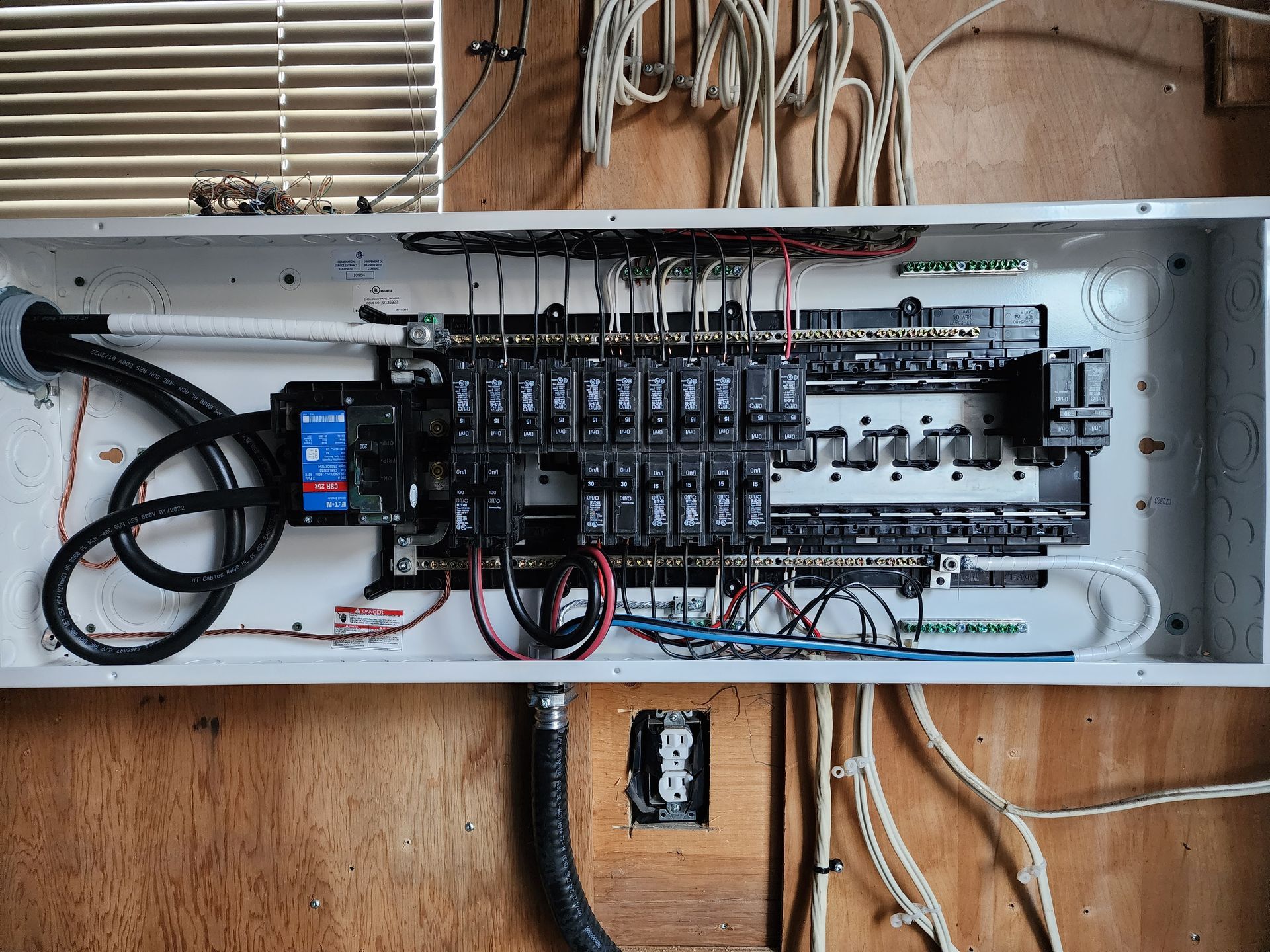 An electrical box with a lot of wires coming out of it.