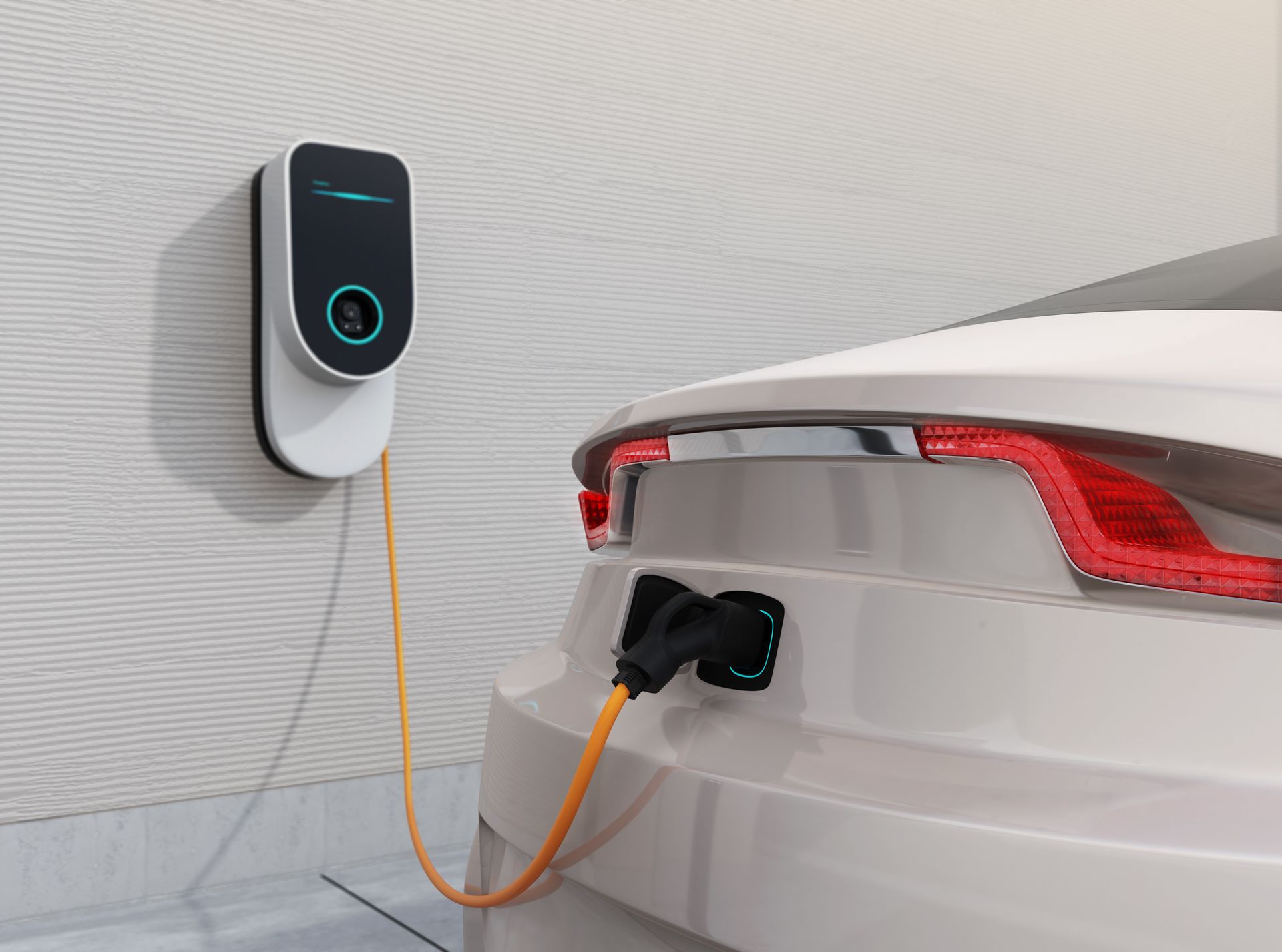 A white electric car is being charged at a charging station.