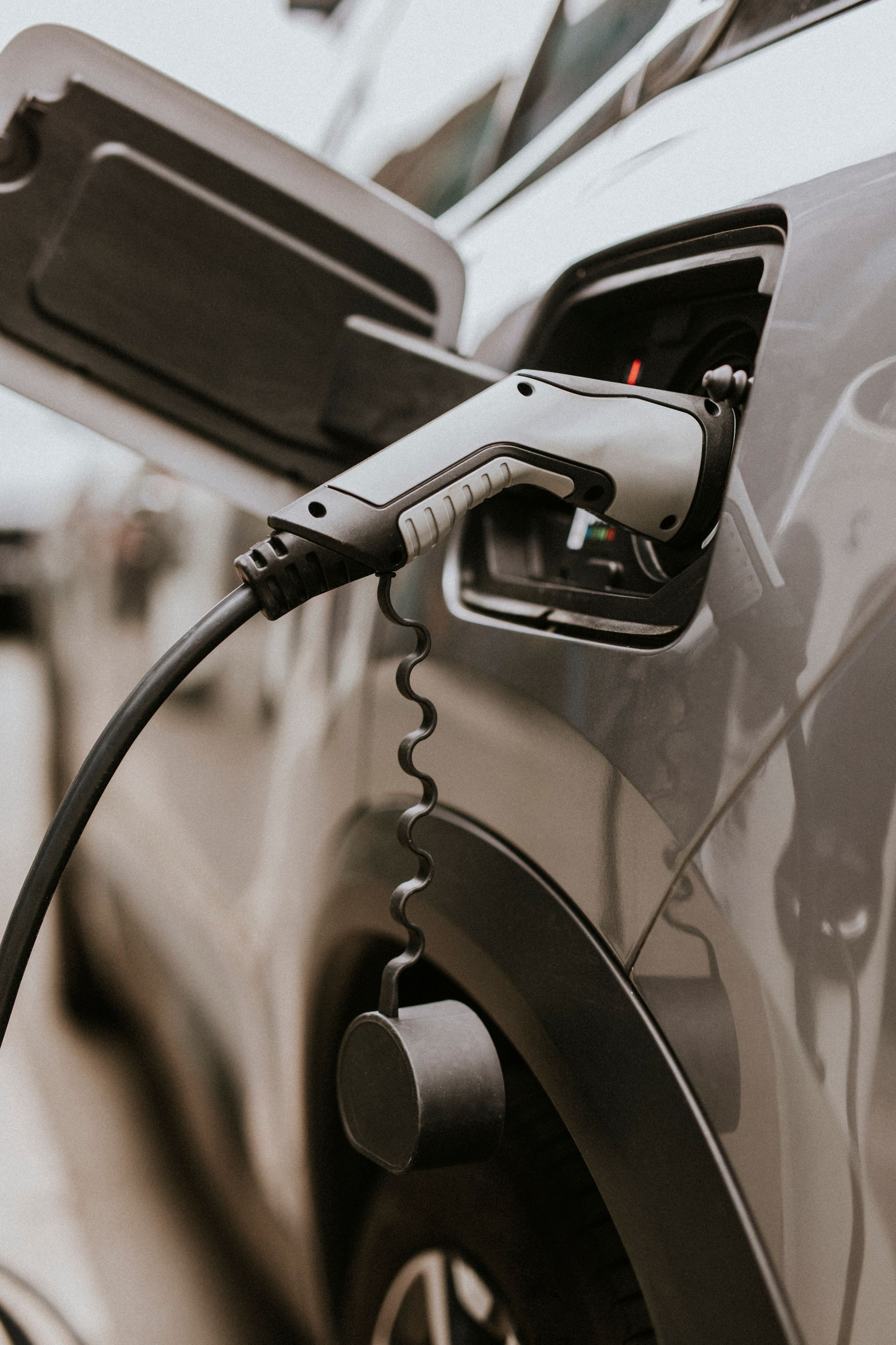 A close up of an electric car being charged