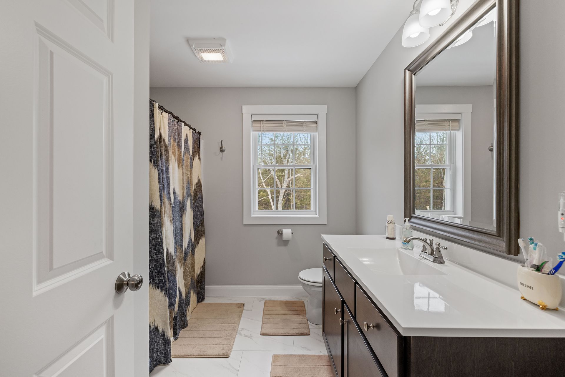 A bathroom with two sinks and a large mirror.