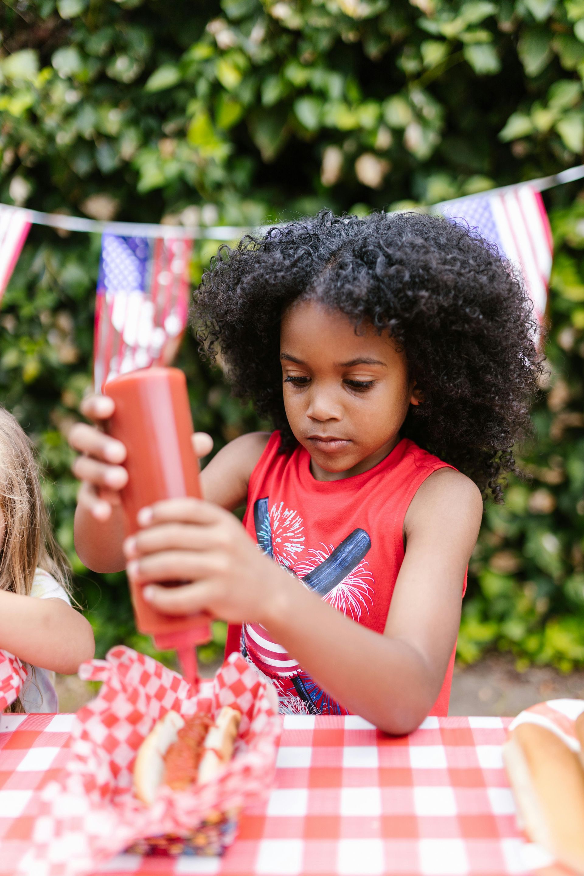 Runners in a race wearing hydration packs and hats, smiling. Outdoor setting.