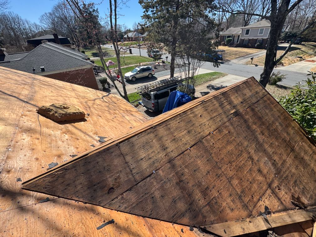 A roof is being repaired in a residential area.