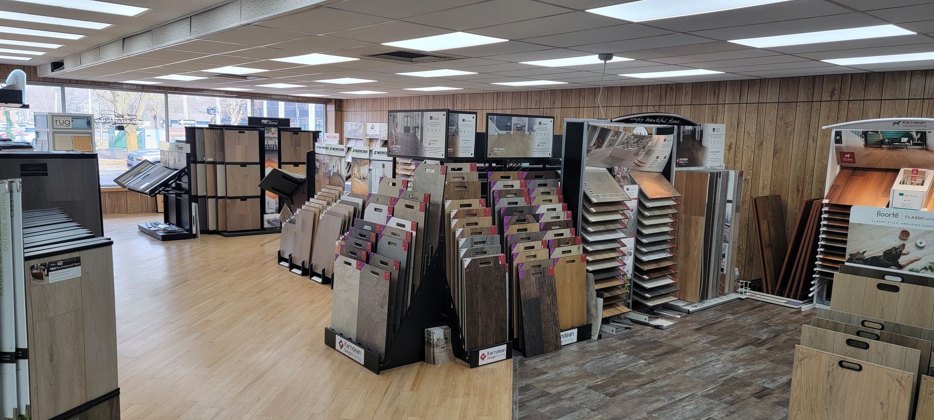 Interior of a flooring store displaying various samples of flooring options. Bright overhead lighting. Interior of a flooring store displaying various samples of flooring options. Bright overhead lighting.