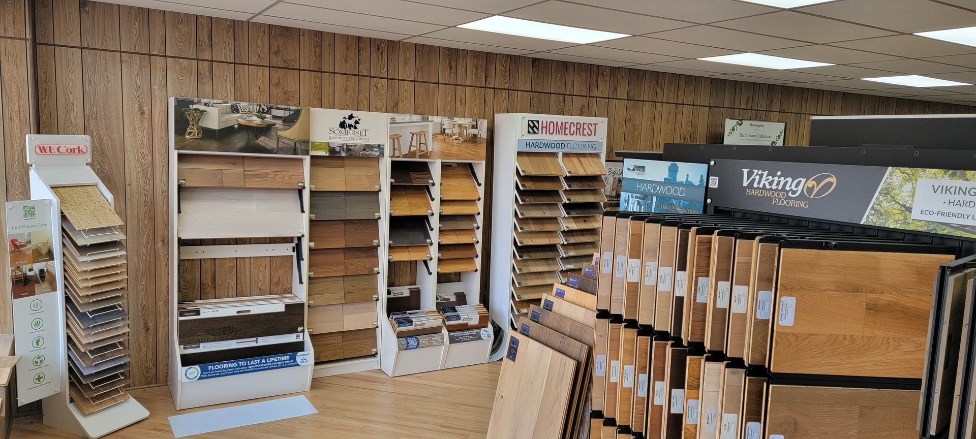 A flooring store interior with displays of wood flooring samples.