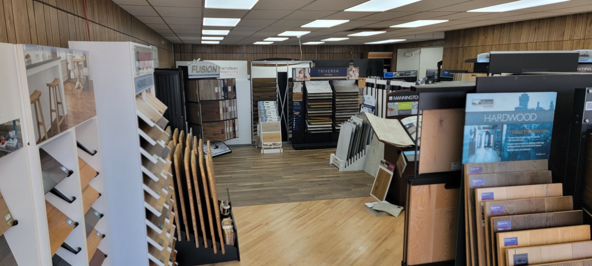 Interior of a flooring showroom with displays of various wood and tile samples. Interior of a flooring showroom with displays of various wood and tile samples.