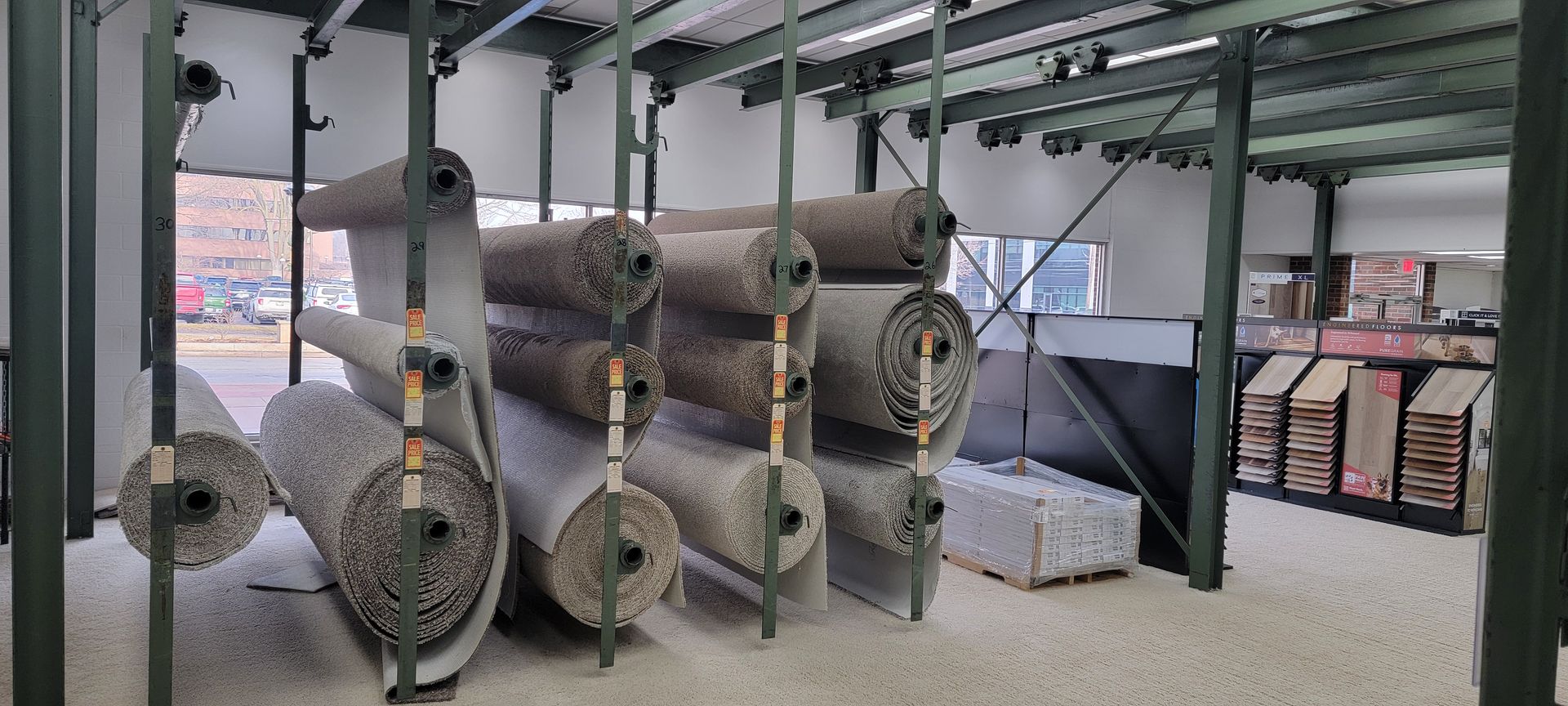 Rolls of carpet on display racks in a warehouse. Rolls of carpet on display racks in a warehouse.