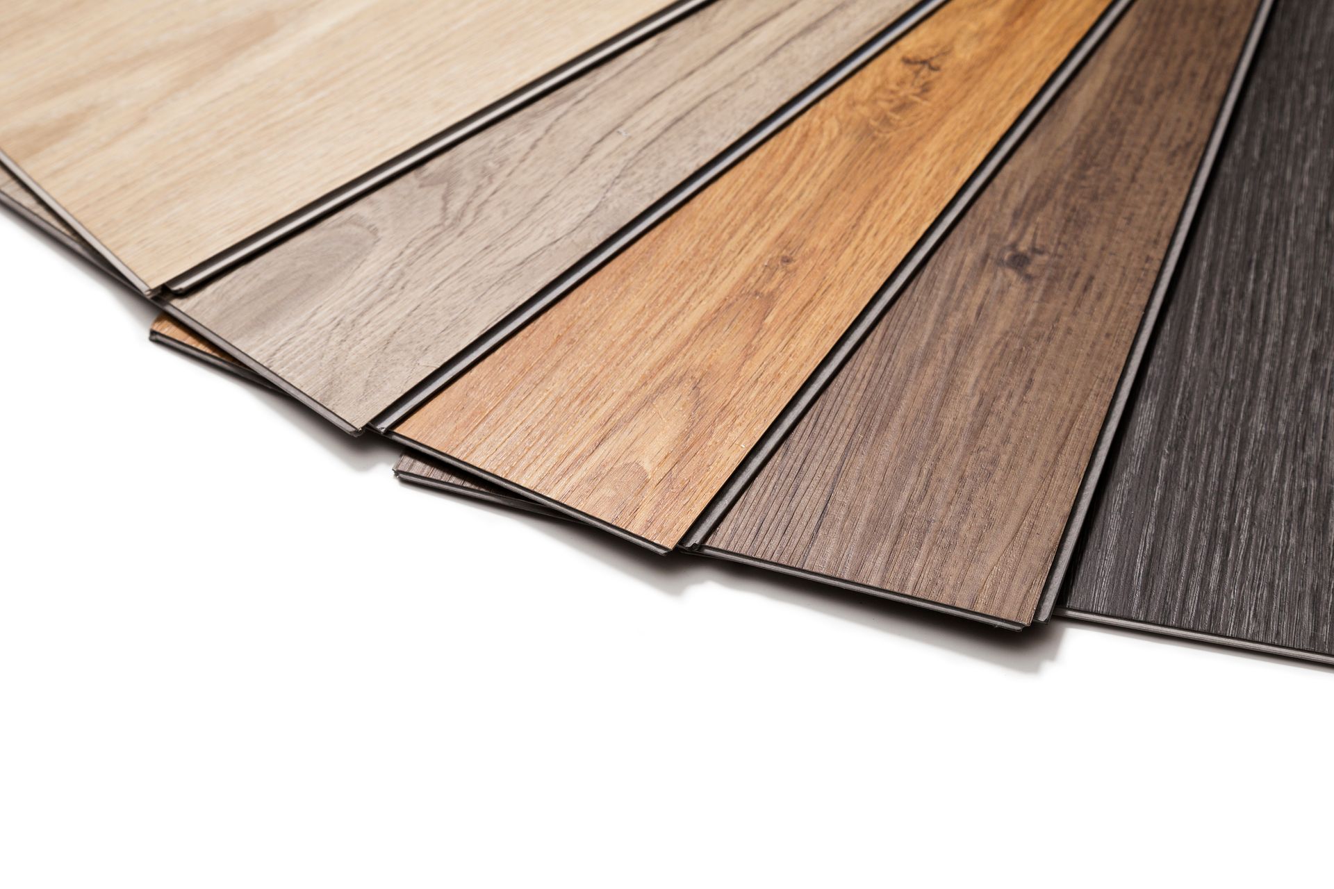 Samples of various wood-look laminate flooring colors, arranged in a fan shape. Samples of various wood-look laminate flooring colors, arranged in a fan shape.