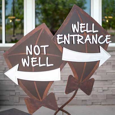 Two brown kite-shaped signs. One says 