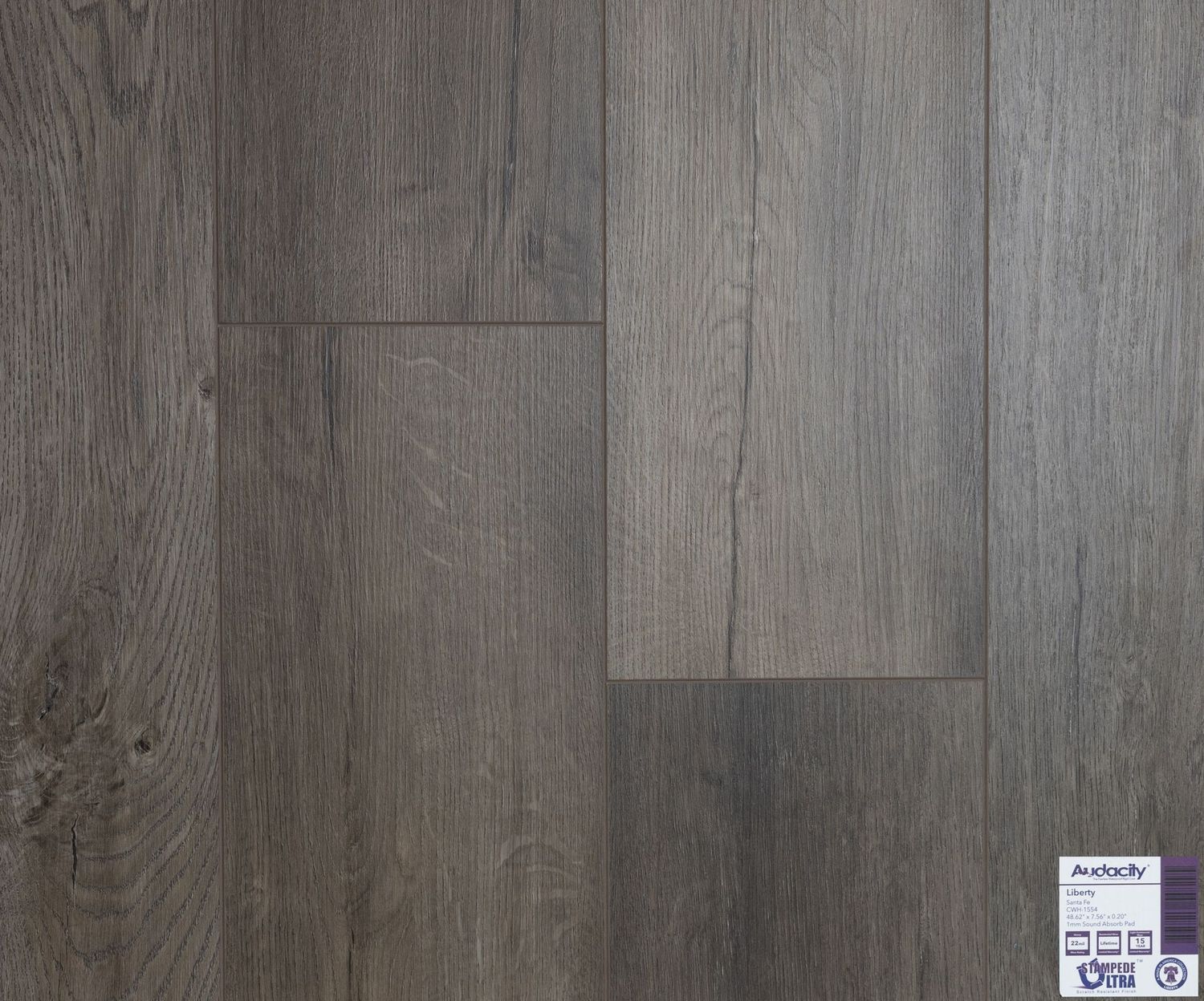 A close up of a gray wooden floor with a label on it.