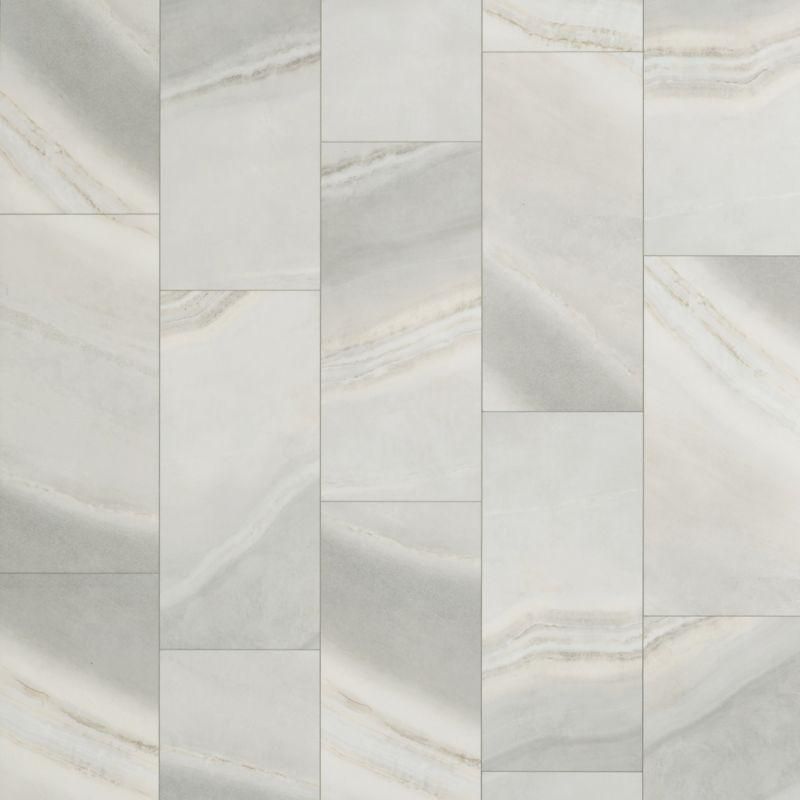 A close up of a white tile floor with a marble texture.