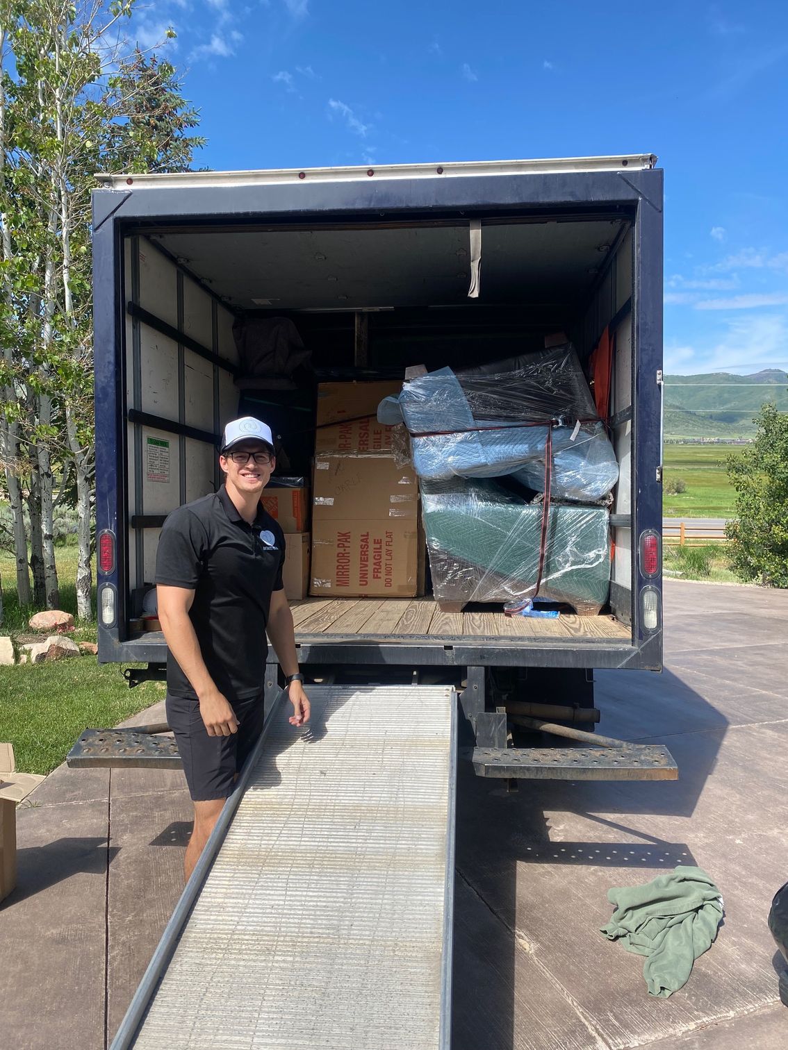 a man is standing in front of a moving truck .