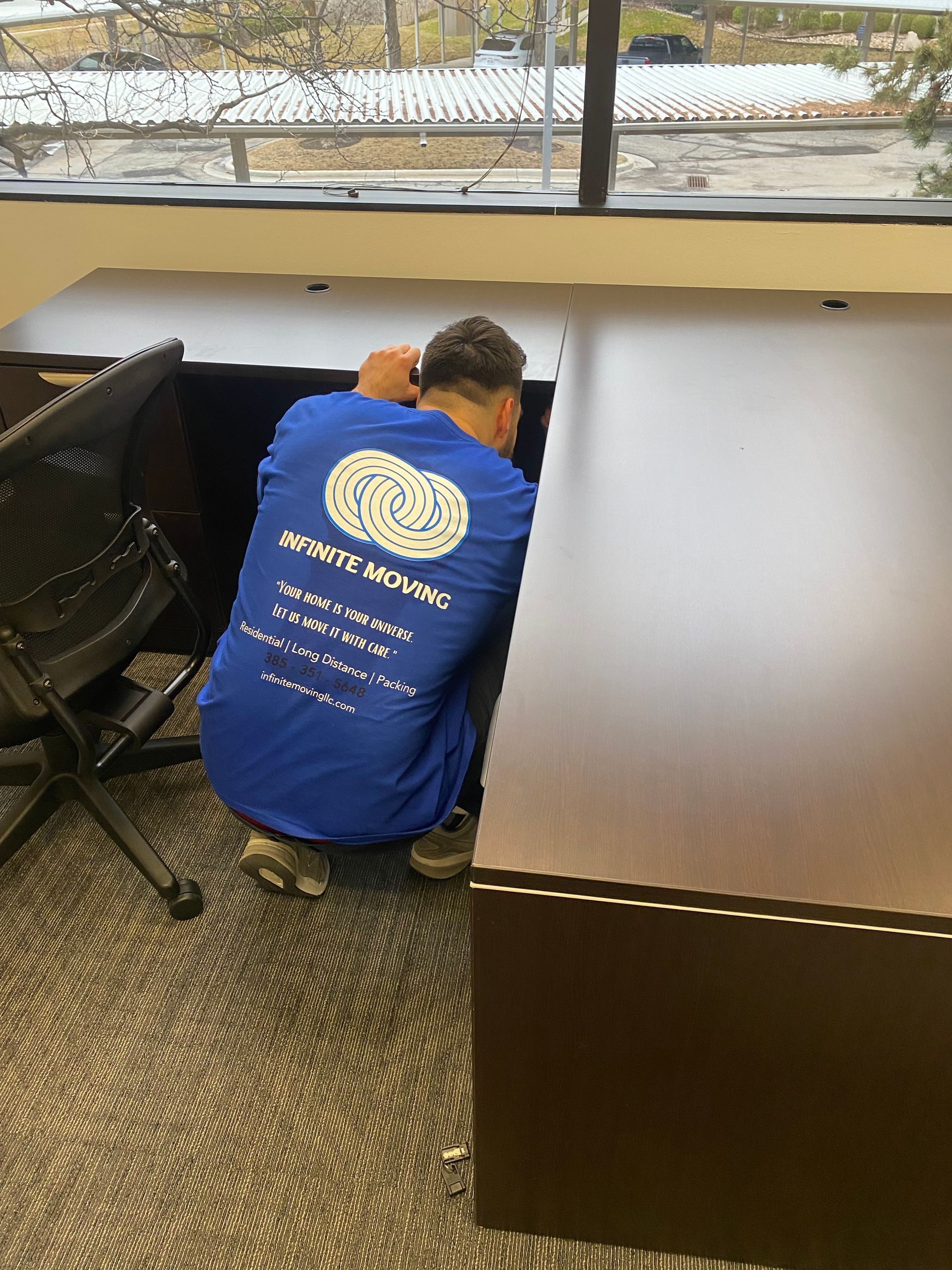 a man and a woman are moving into a new office .