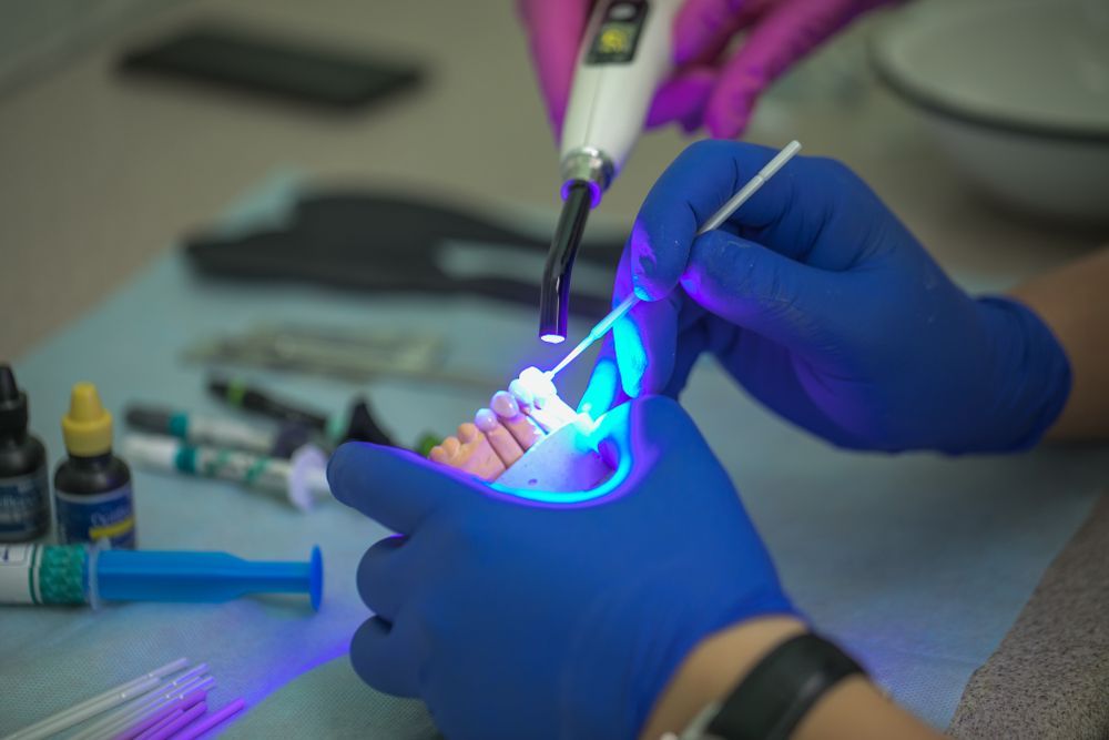 A Dentist Is Working On A Patient 's Teeth With A Light — Mittagong Dental Care In Mittagong, NSW