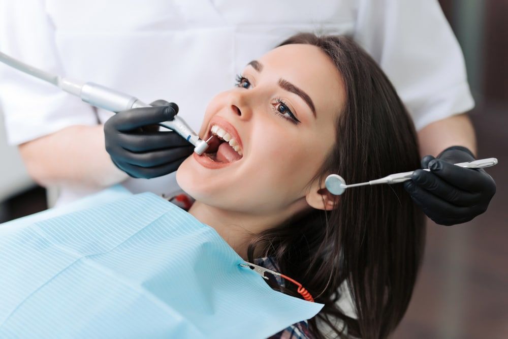 A Woman Is Having Her Teeth Examined By A Dentist — Mittagong Dental Care In Mittagong, NSW