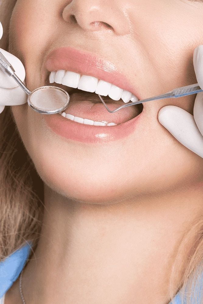 A woman is getting her teeth — Mittagong Dental Care In Mittagong, NSW