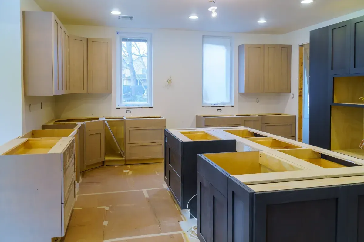 Partially renovated kitchen with unfinished cabinets and dark island cabinets under construction - Yucaipa CA Kearney Restorations