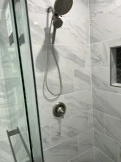 Updated bathroom with modern tile design by Kearney Restorations