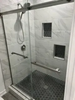 Bathroom shower renovation with updated plumbing fixtures by Kearney Restorations
