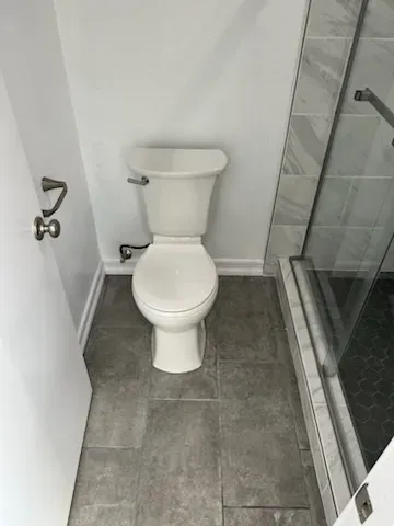 Modern toilet upgrade in bathroom remodel by Kearney Restorations