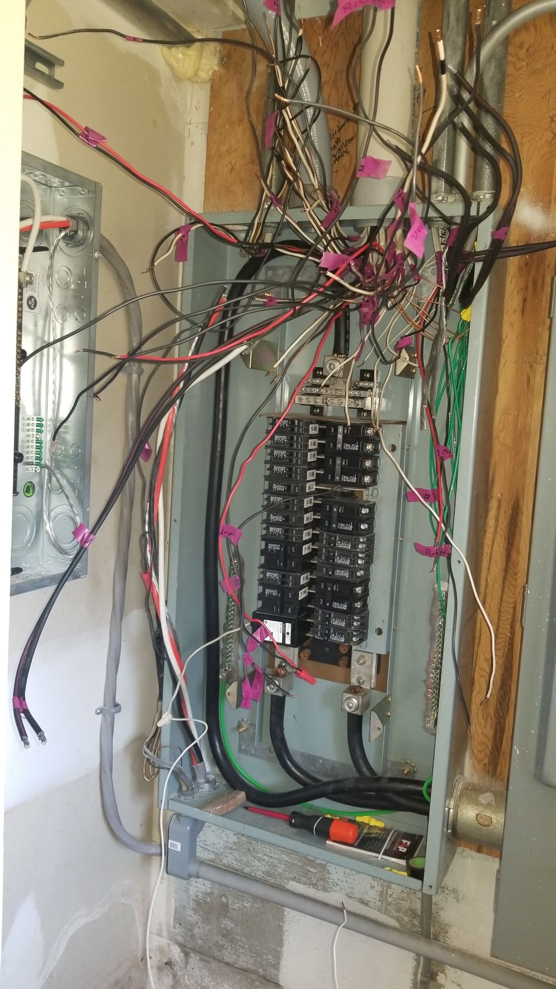 A very messy electrical box with a lot of wires coming out of it.