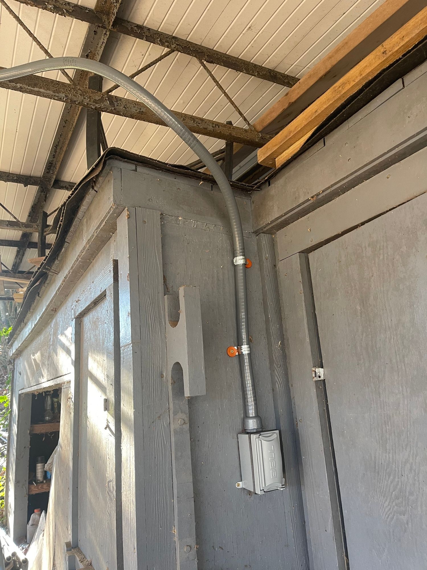 A pipe is hanging from the ceiling of a building.