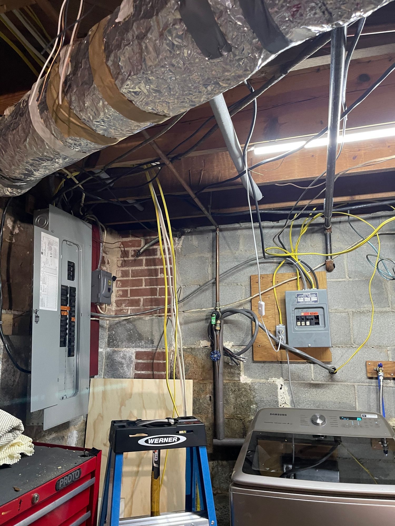 A room with a lot of wires hanging from the ceiling.