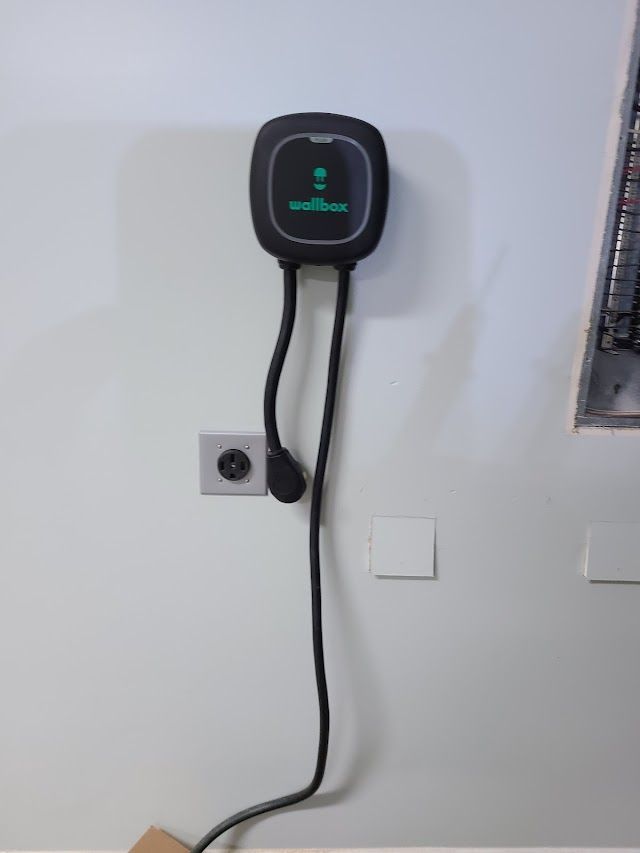 A charger is plugged into a wall outlet.