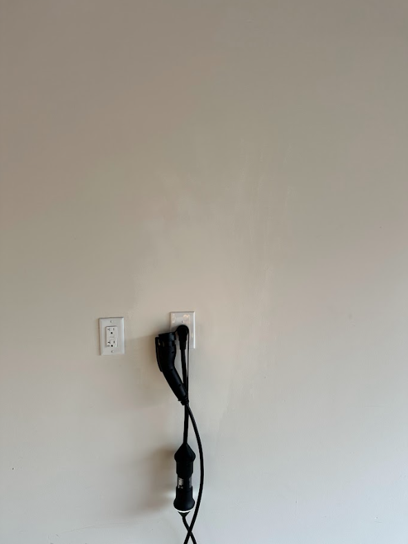 A hair dryer is plugged into a wall outlet.