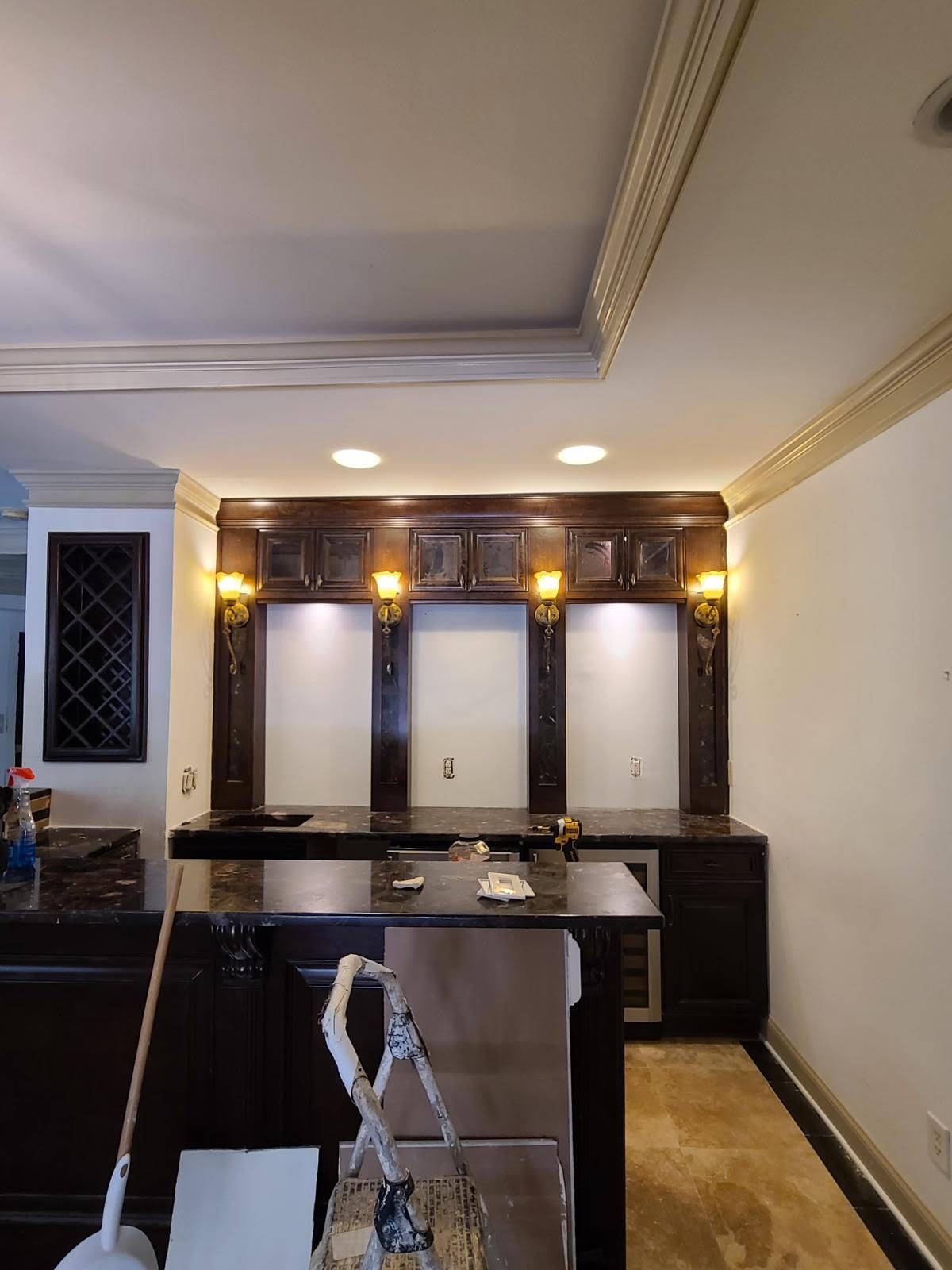 A kitchen with stainless steel appliances and black cabinets
