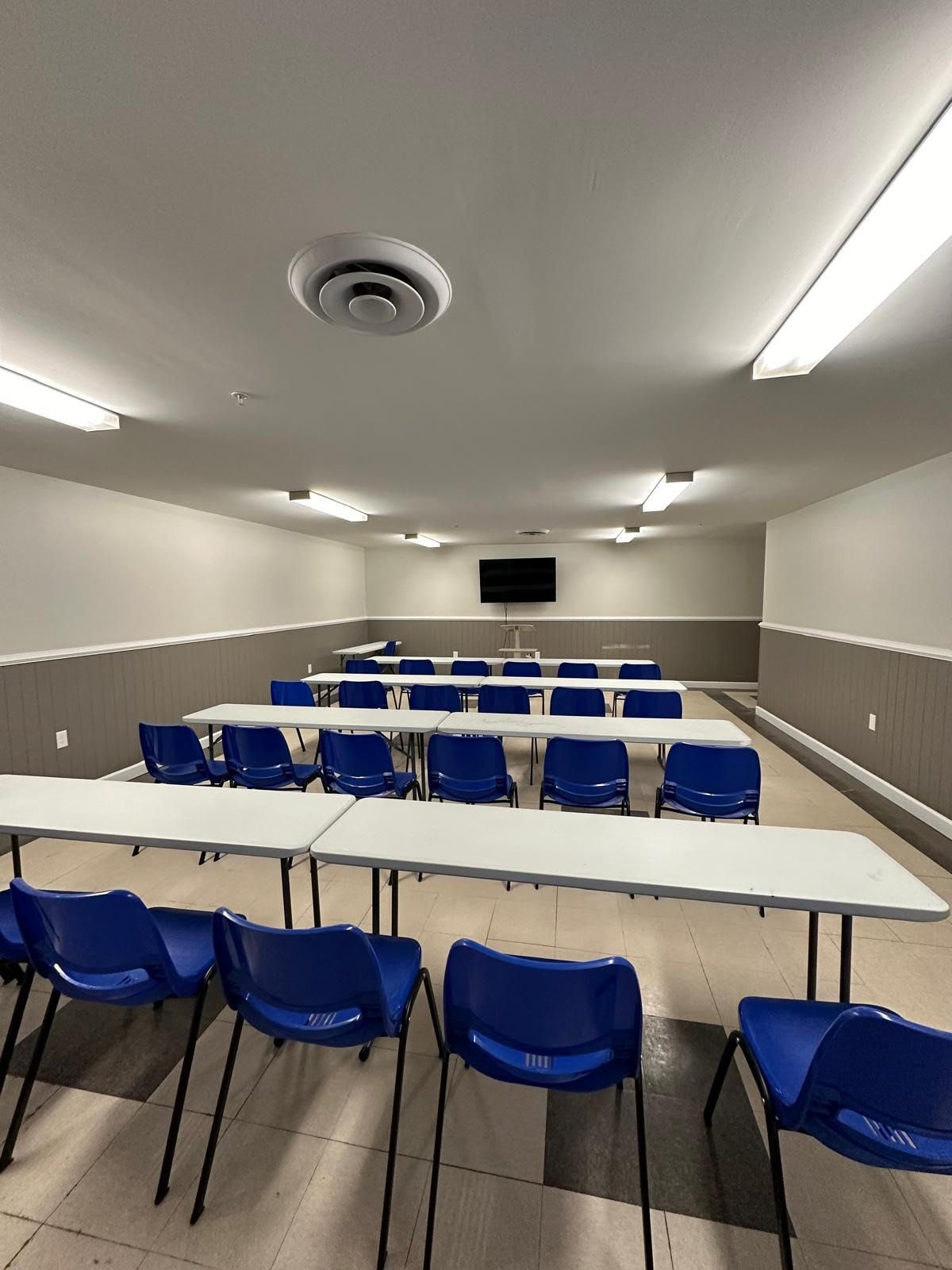 A large room with tables and chairs in it