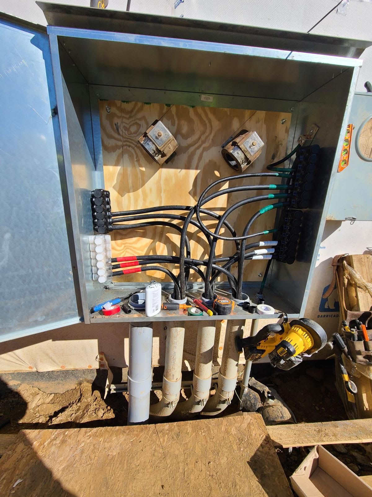 A box with a lot of wires and pipes inside of it.