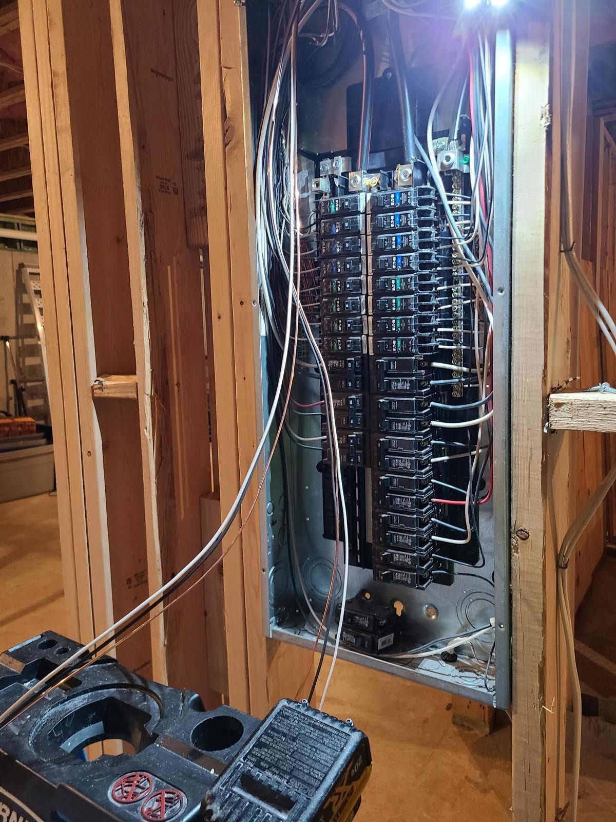 A electrical panel is being installed in a house under construction.