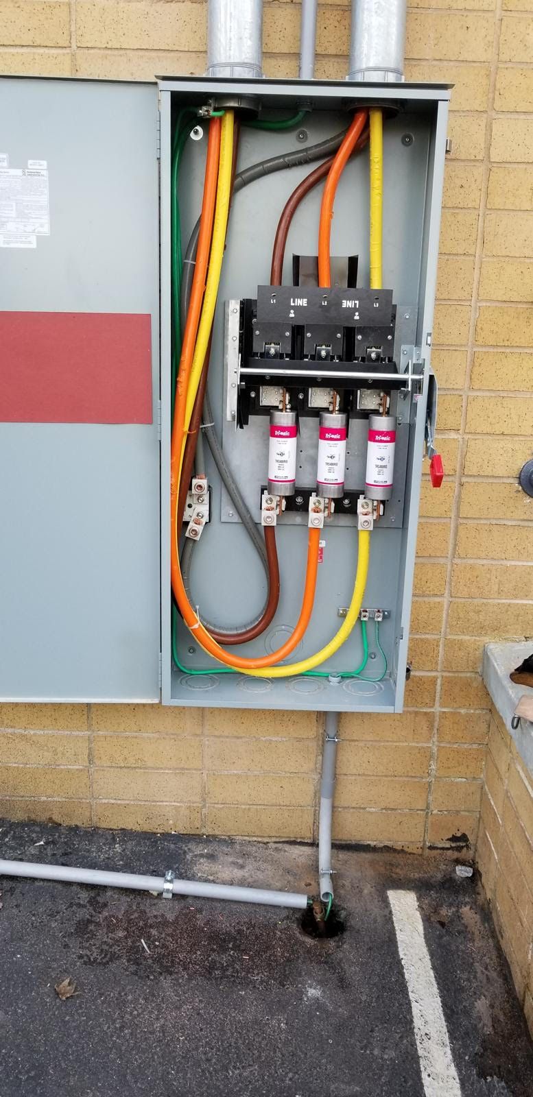 A electrical box with a lot of wires coming out of it.