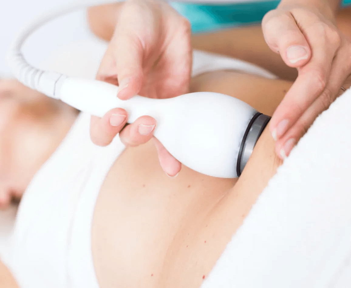 Uma mulher está fazendo um tratamento de ultrassom na barriga.