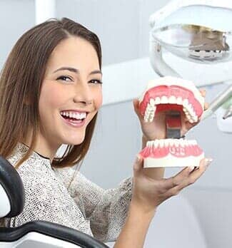 Dentist patient smiling with a plastic denture — Dental Office in Virginia Beach, VA