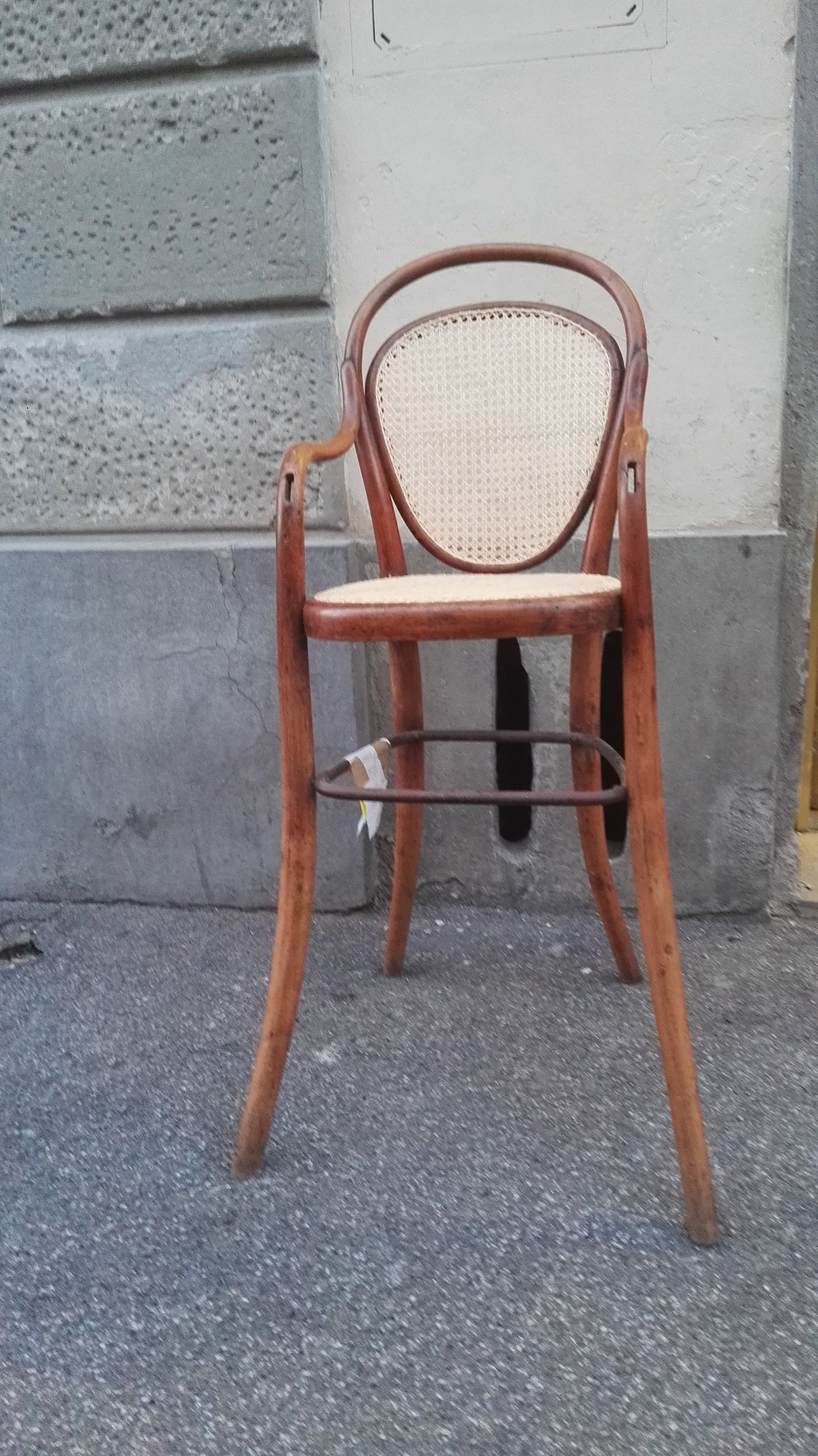 particolare sedia di legno con schienale e seduta in paglia intrecciata in piccole trame a rete