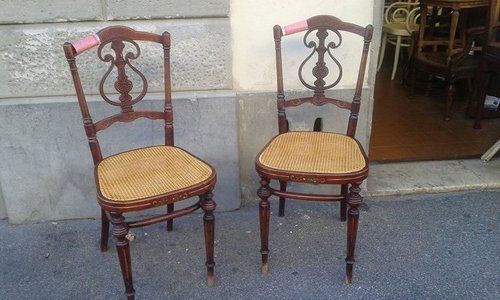 two upholstered antique chair next to eachother