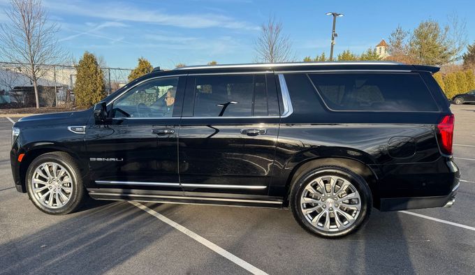 A black suv is parked in a parking lot.