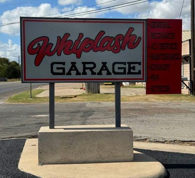 A sign that says whiplash garage on it