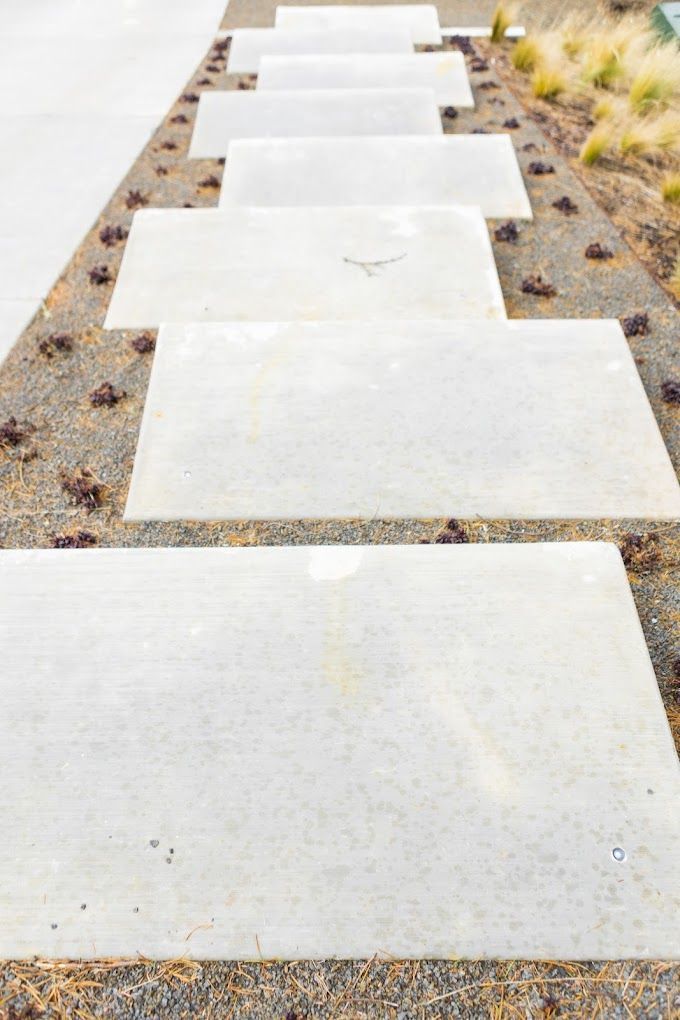 A row of white concrete steps leading up to a house.