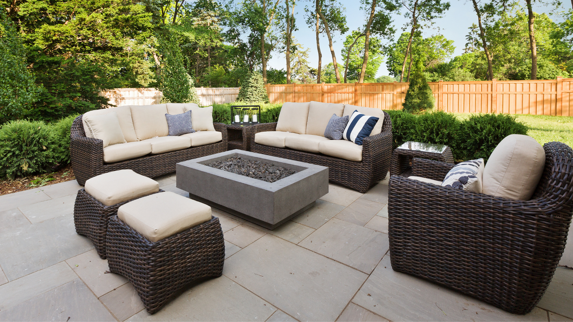 A patio with wicker furniture and a fire pit