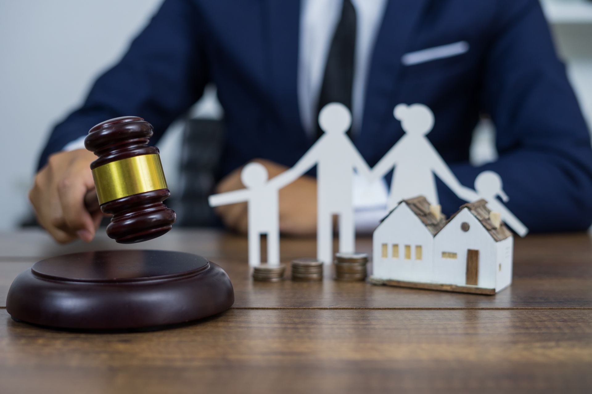 Family figure and gavel symbolizing legal support from a trusted family law attorney.