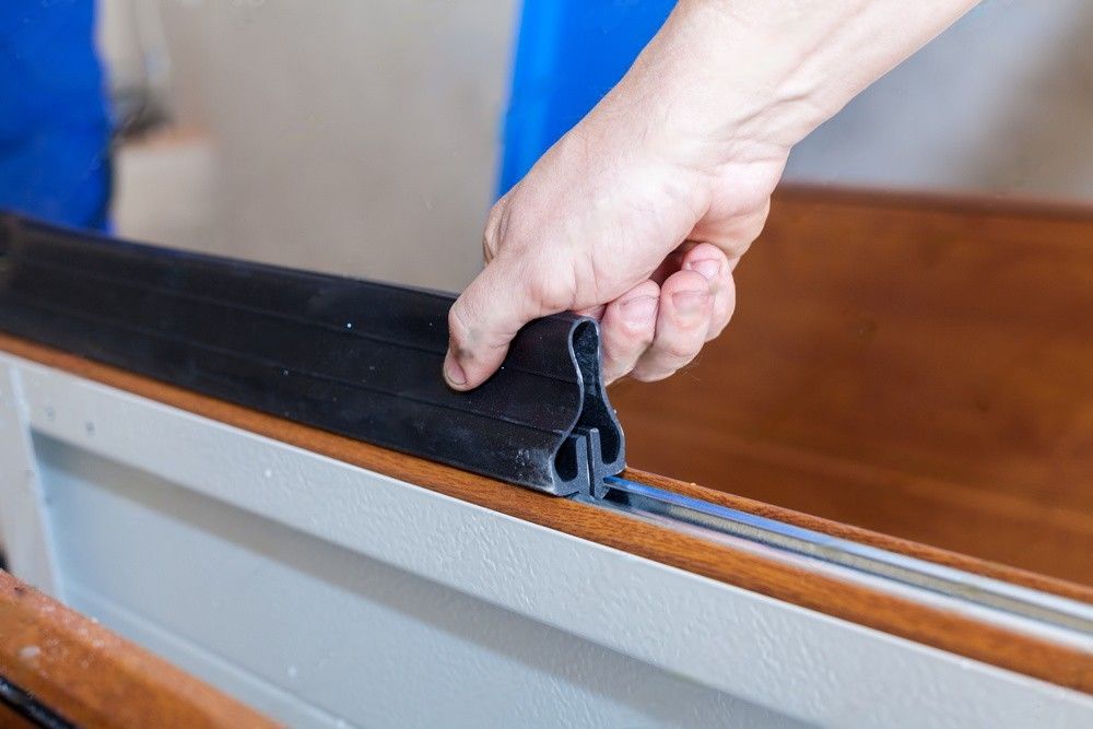 A professional technician installing a new garage door.