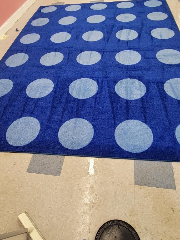 A blue rug with white polka dots on it