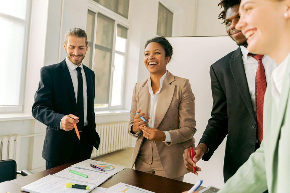 A group of business people are having a meeting in an office.