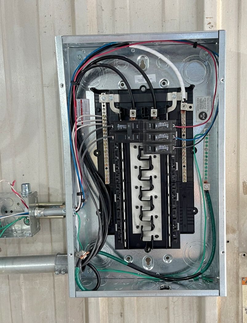 A close up of a electrical box with wires coming out of it.